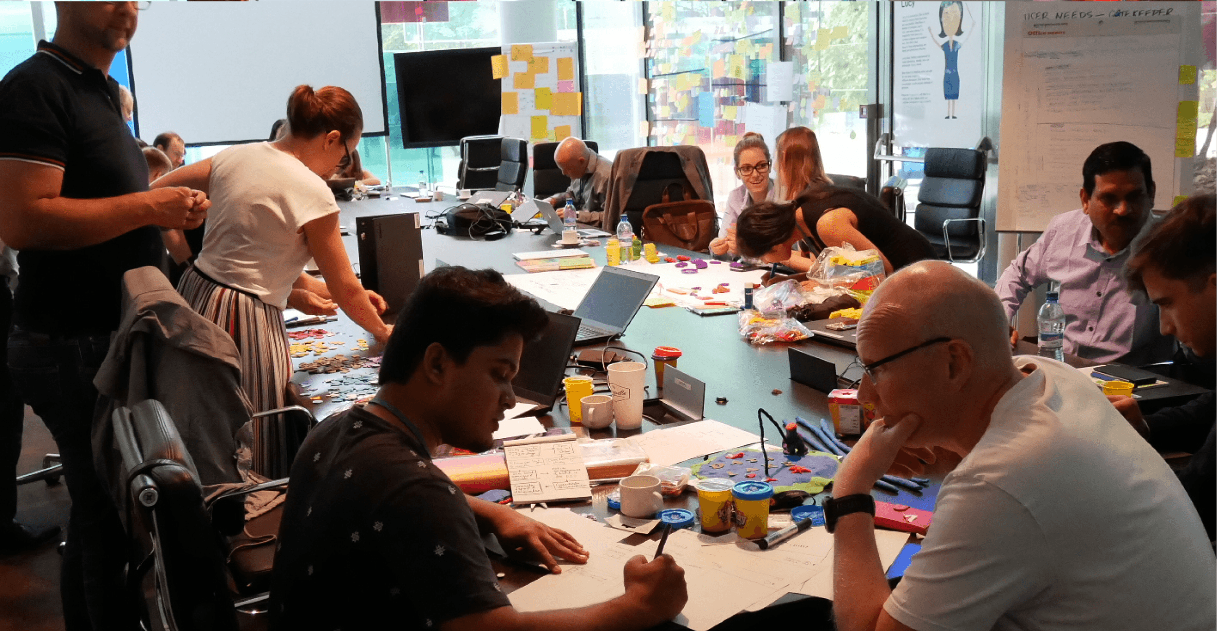 Stakeholders from operations, management, and leadership collaborating during the two-day design-thinking workshop at client HQ